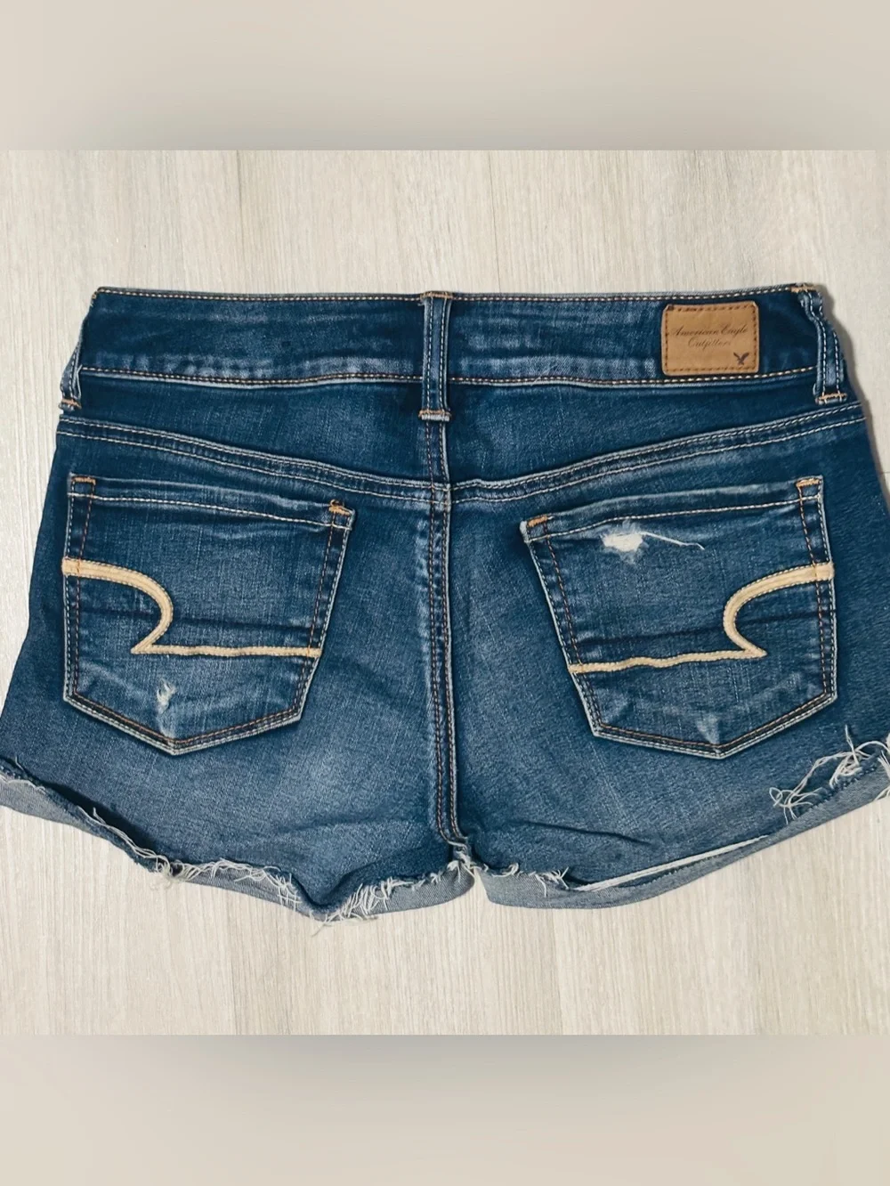 American Eagle stretch low rise distressed dark denim cut off shorts raw hem  2